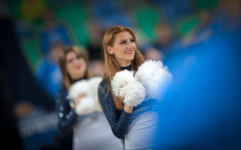 Female cheerleader performing in basketball court at Arena Stozice, Ljubljana, Slovenia.