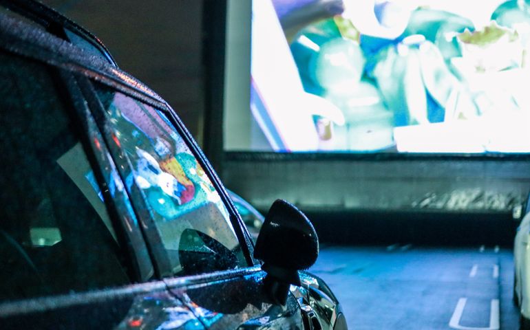 people enjoying in their car at a theater