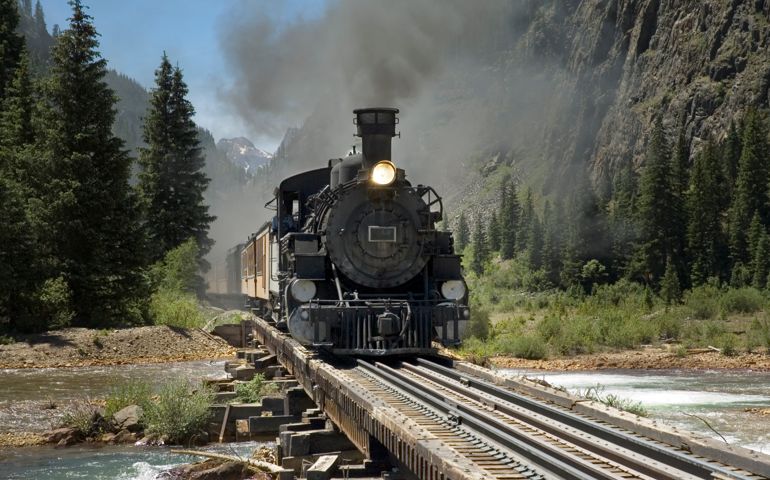 Narrow gauge steam powered train crosses the Animus River on its way to Silverton from Durango, Colorado.
