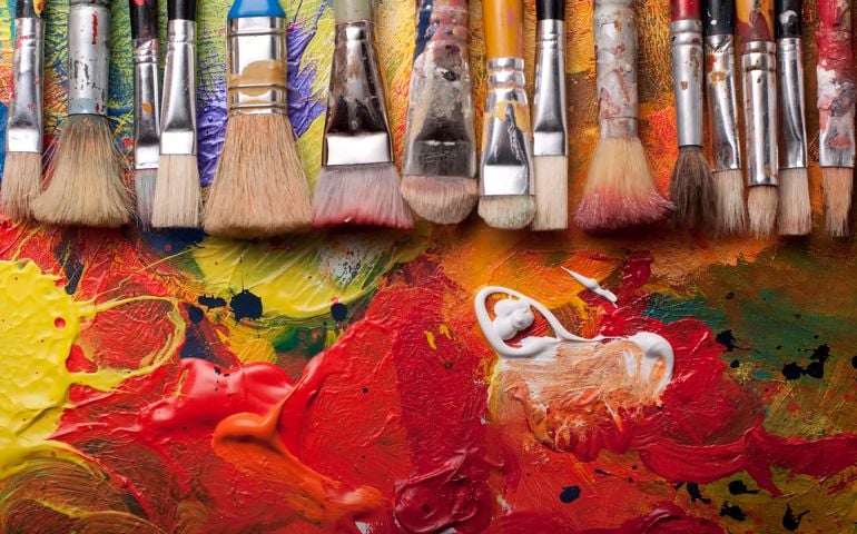 Paint brushes in a row,pallete at background,studio shoot