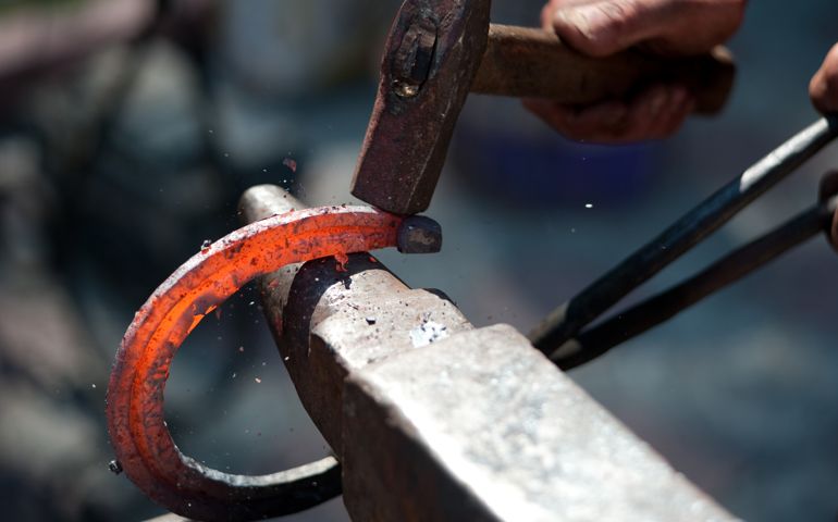 red hot horseshoe on the anvil