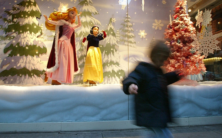 NEW YORK - NOVEMBER 14: A girl walks in front of a holiday display in a window of the Walt Disney store November 14, 2002 in New York City. Many stores in the city are already decorated with Christmas lights and displays in anticipation of the holiday shopping season.