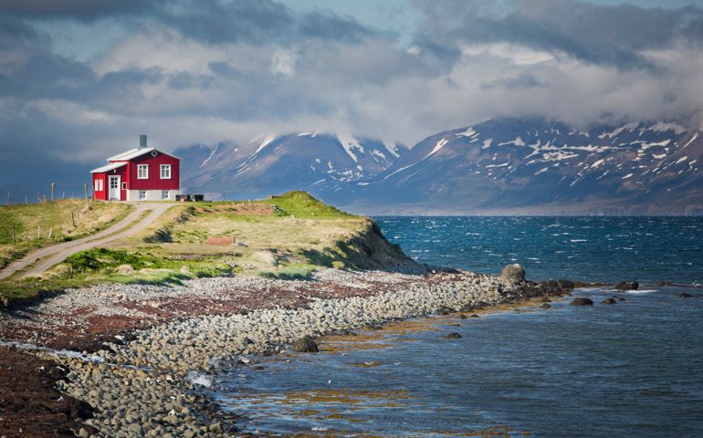 Red house next to a fjord in north Iceland.