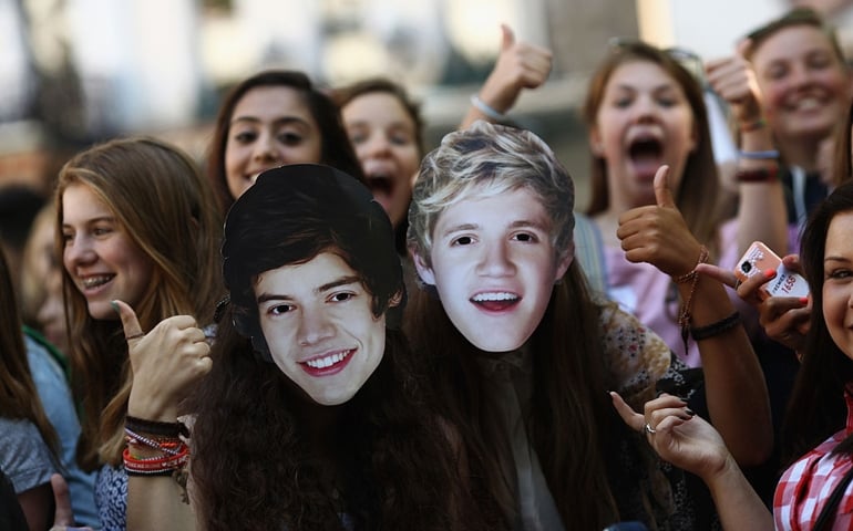 One Direction fans take their positions in Leicester Square ahead of the premier to the bands new film on August 20, 2013 in London, England. The bands new film, 'This Is Us', will premier this evening at the Empire cinema.
