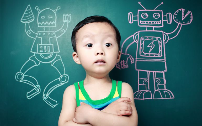 Cute child in front of the blackboard