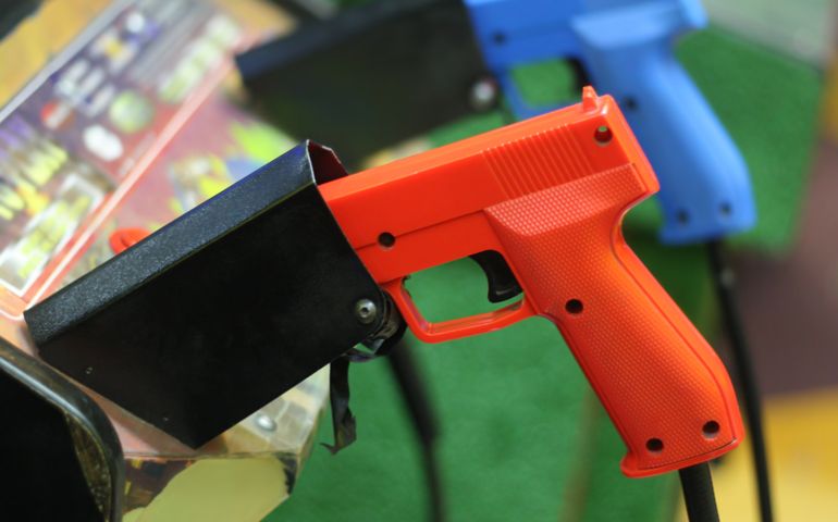 Colorful game guns in an arcade.