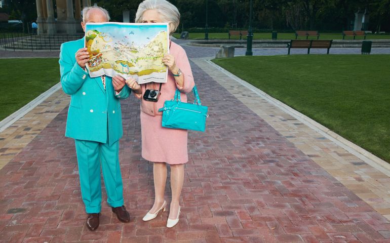 Senior couple looking at map outdoors