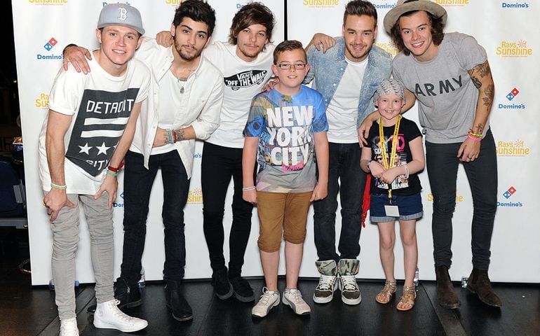 Zayn Malik, Niall Horan, Louis Tomlinson, Liam Payne and Harry Styles of One Direction pose for photographs with Amie Sluman and guest at Wembley Arena as they made the wishes of 60 seriously ill children come true and met the children prior to performing at Wembley Stadium on June 8, 2014 in London, United Kingdom. The band are ambassadors for Rays of Sunshine, a children's charity which grants wishes for seriously ill children in the UK. www.raysofsunshine.org.uk