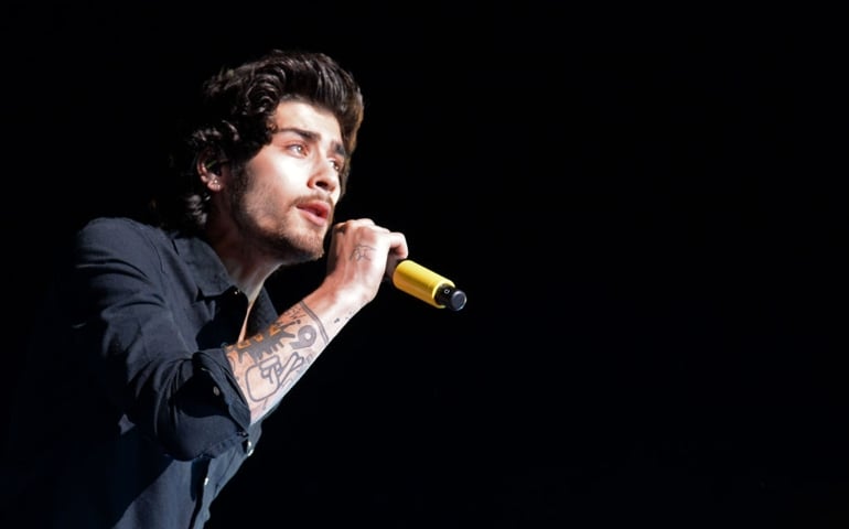 Singer Zayn Malik of One Direction performs onstage during the One Direction" Where We Are" Tour at Rose Bowl on September 11, 2014 in Pasadena, California.