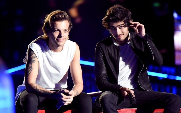 Singers Louis Tomlinson (L) and Zayn Malik of One Direction perform onstage during the One Direction" Where We Are" Tour at Rose Bowl on September 11, 2014 in Pasadena, California.