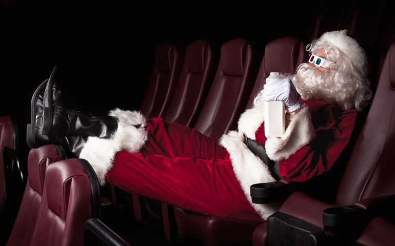 Santa Claus enjoys his day off at the movie theater.