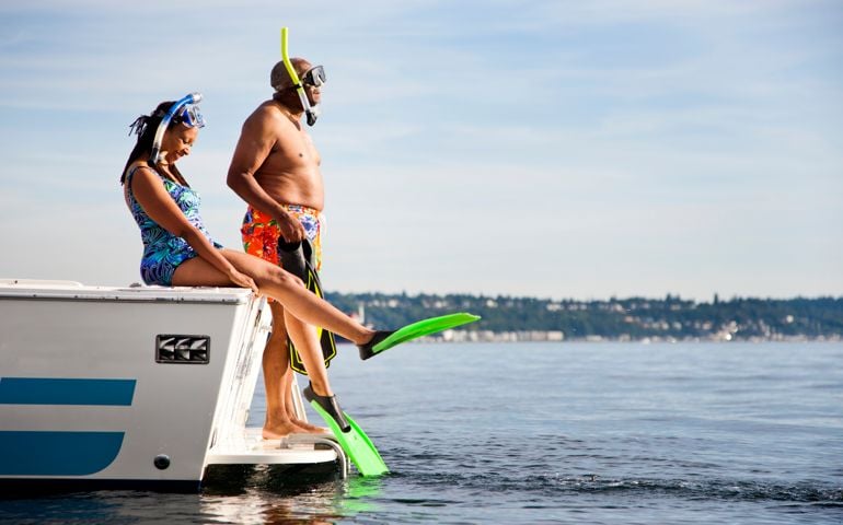 Couple in snorkeling gear on boat