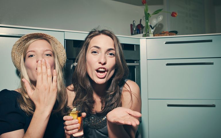 Two young women sending kisses towards camera