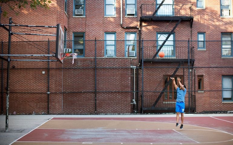 Man playing basketball outdoors