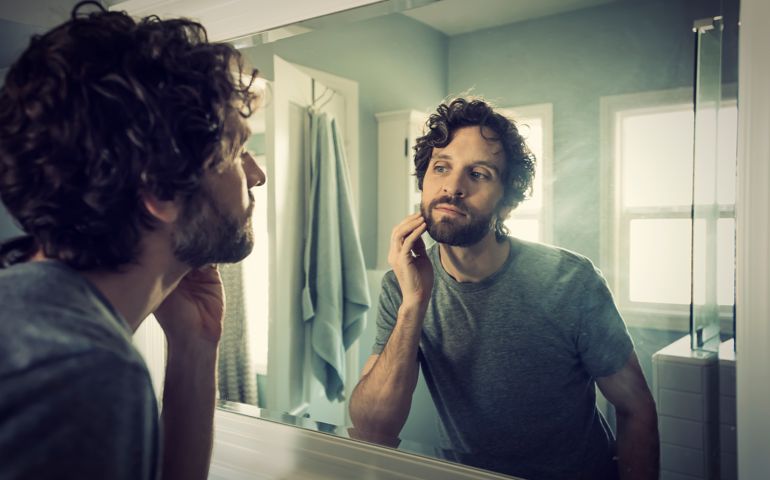 Man grooming in bathroom