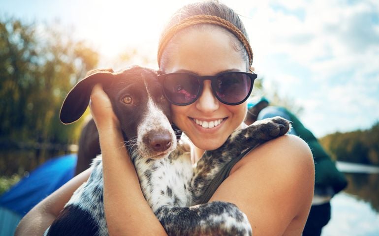 Shot of a young woman out camping with her dog