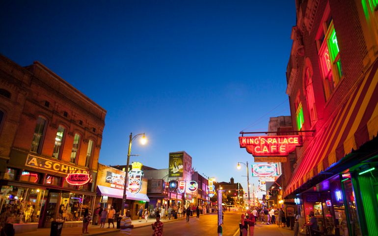 Memphis, TN, USA - June 25, 2017: View of a crowd of tourists enjoying the music clubs and retail establishments that line the famous music district of Beale Street in downtown Memphis, TN at dusk. Beale Street is on the U.S. National Register of Historic Places.