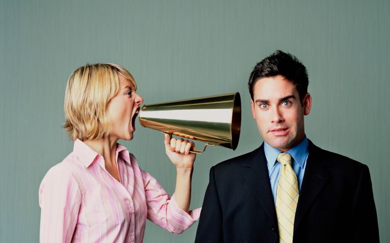 Woman shouting at men with phone