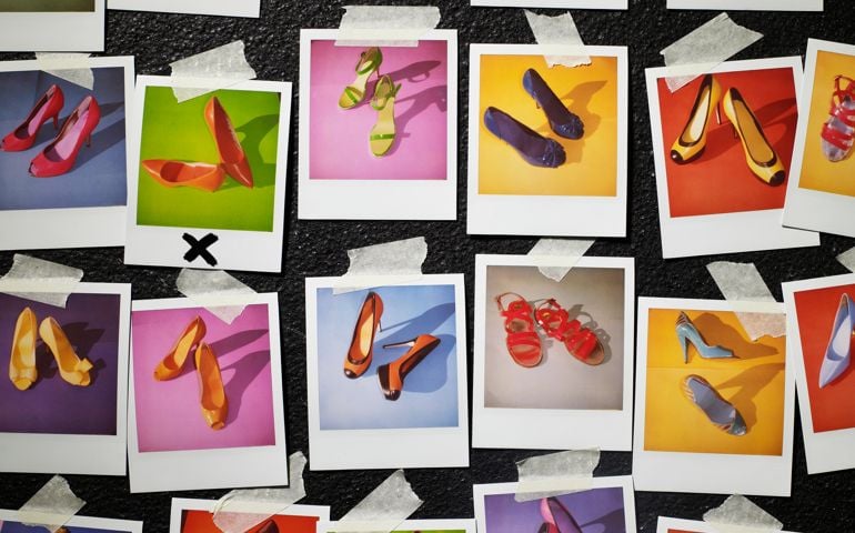 Polaroids of shoes taped to wall