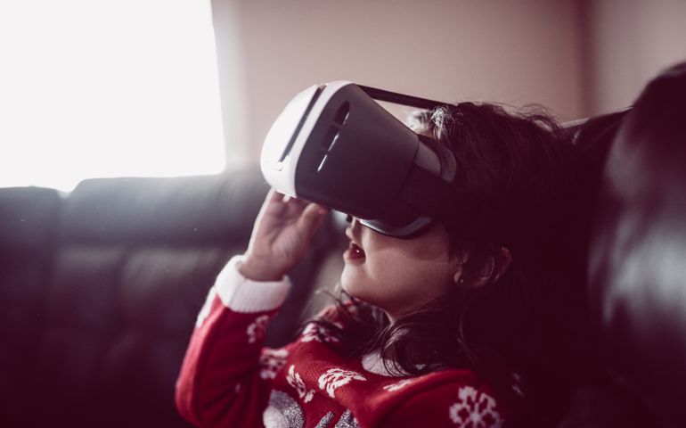 Little Girl Having Fun with Virtual Reality Simulator at Home