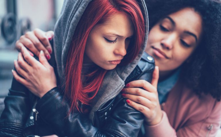 Teenage girl supporting friend