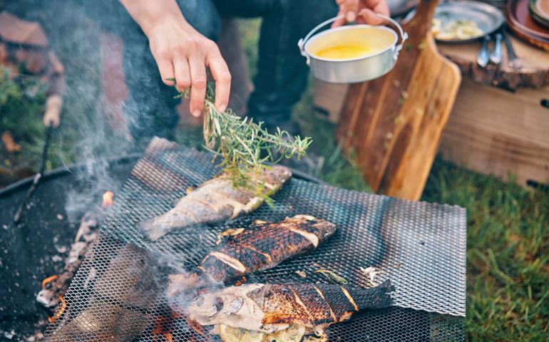 Preparing Fish for Cooking Over Open Campfire