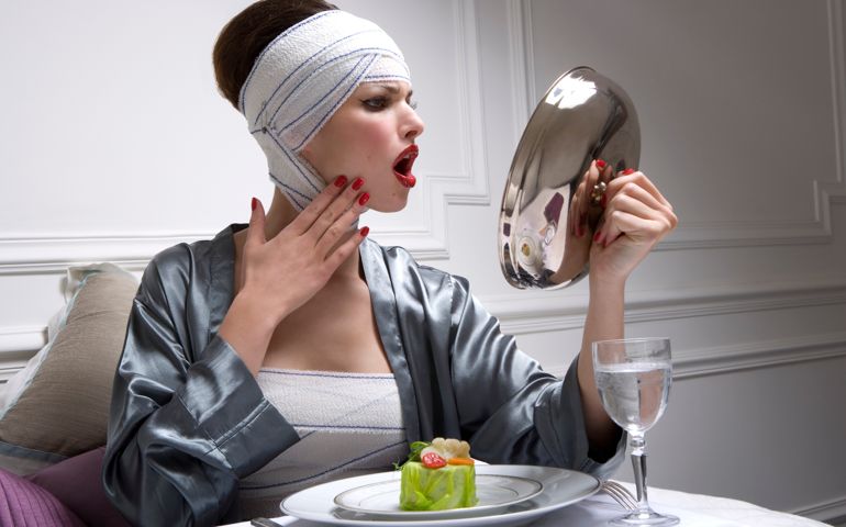young women looking her in a silver lid in a luxury clinical