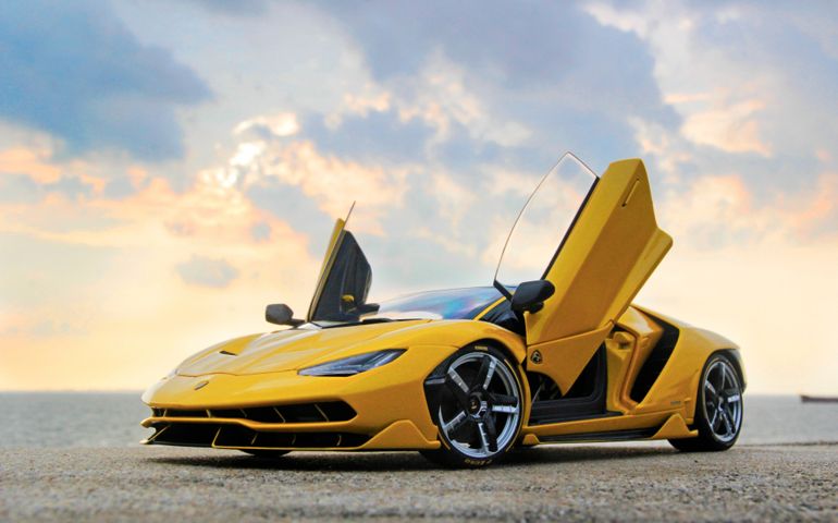 Yellow Lamborghini Centenario in a sea port