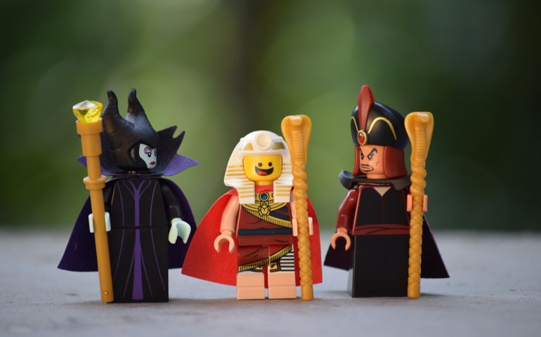 Three Lego mini figures from different sets. Lego Benny, Jafar and an evil witch. Lego is a brand/company from Denmark.