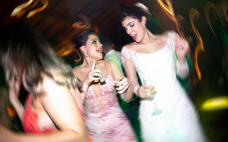 Bride and wedding guest dancing during wedding reception