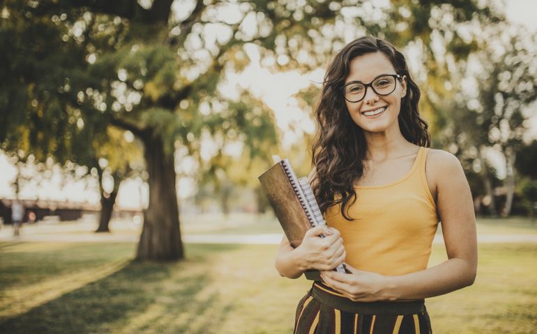 Portrait of happy student in the park