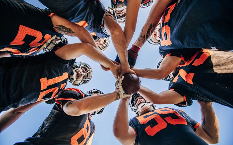 American Football Players Huddling During Time Out
