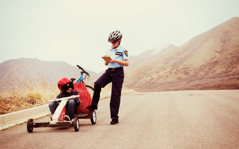 a young boy gets pulled over for speeding in his go-cart.