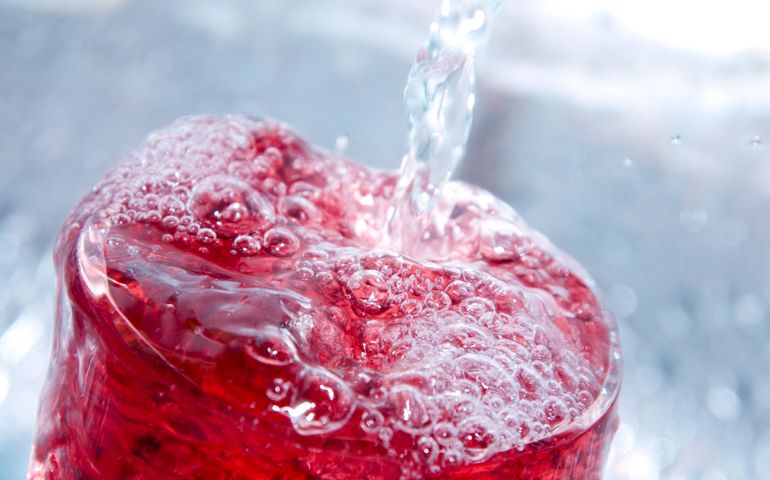 A refreshing juice drink mixed with ice cold spring water. Shallow DOF, with main focus on front surface of drink.
