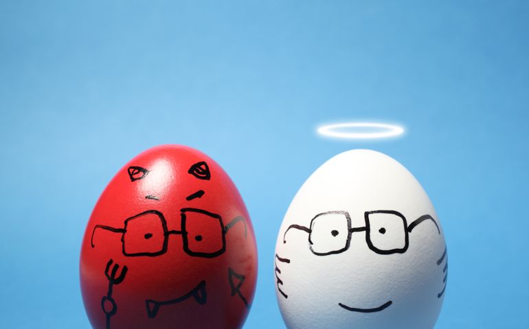"Close-up of evil and angel eggs, against blue background."