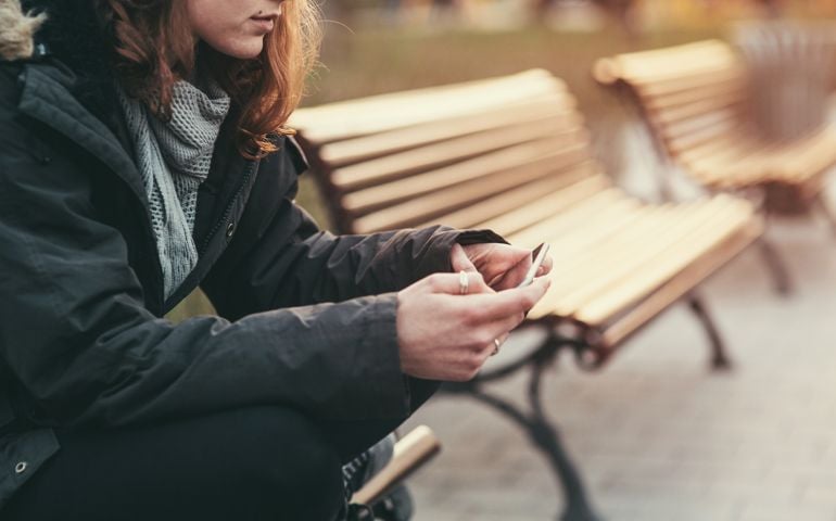 Teenage girl feeling depressed after breaking up with her boyfriend through messages