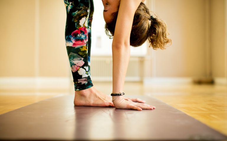 Young woman practicing Vinyasa yoga