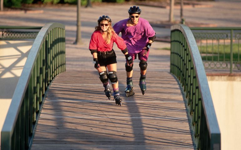 Two Inline Skaters Crossing Footbridge