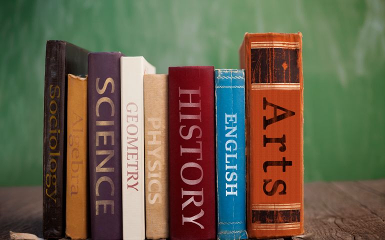Various class books on wooden table