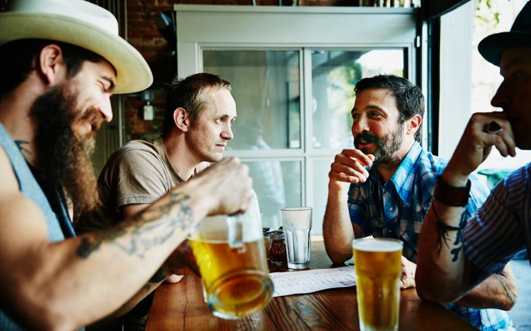 Group of friends sharing drinks in restaurant
