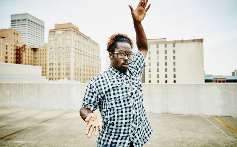 Man dancing on rooftop of building