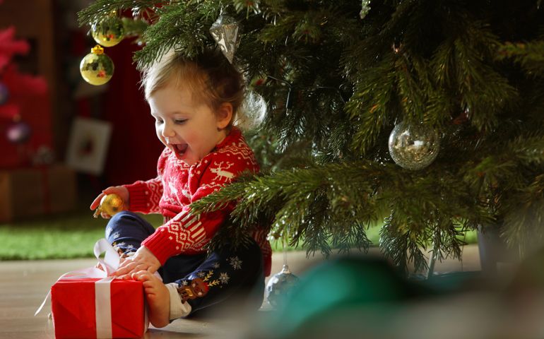Toddler girl with Christmas tree