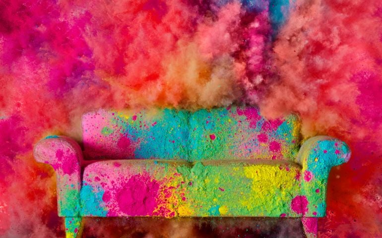 A brightly colored couch covered in paint powder