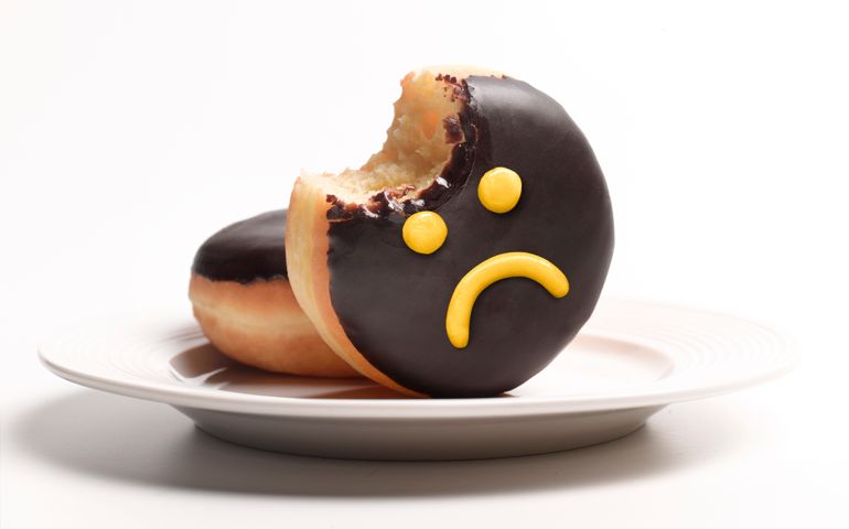 Unhealthy doughnut on plate