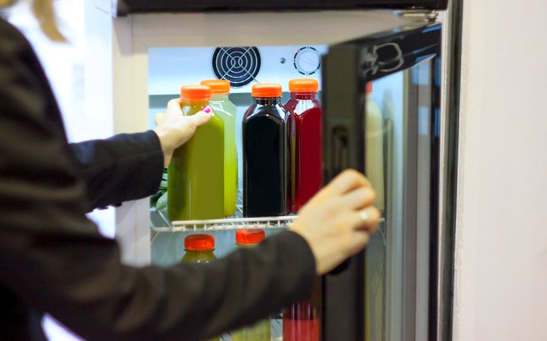 Green, red, black fruit drink in plastic or glass bottles