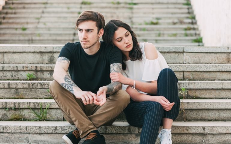 Young people with problems sitting at the staircase