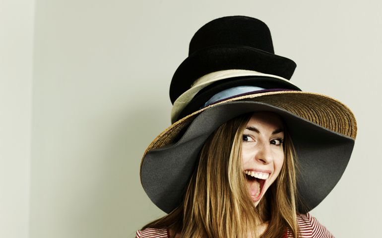 Portrait of woman wearing lots of hats