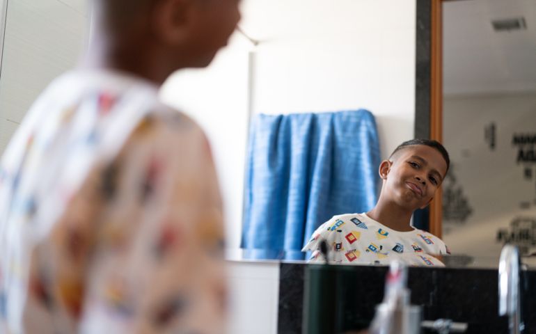 Little Cut Kid Looking to the mirror at morning