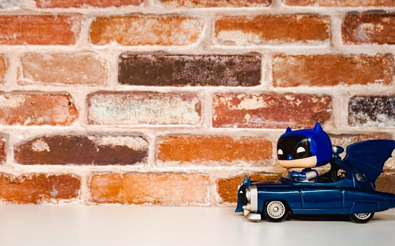Mini batman action figure riding a batmobile