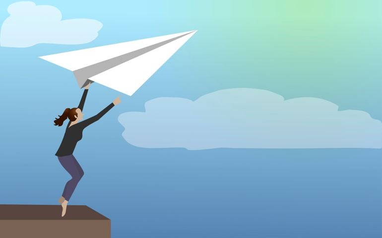 Business leader leaving comfort zone on a paper plane.